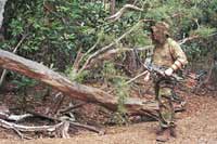Jake Goodwin hunts a dried creek bed in search of feral pigs