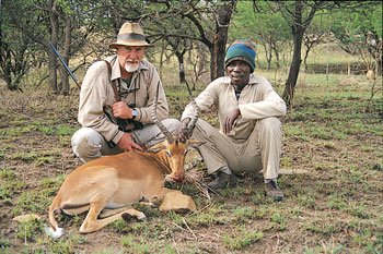 The impala, beautiful and graceful, is common in Africa. Behind it are Zulu tracker, Pumlan, and professional hunter Danilo Pefelli.