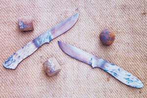 Fresh from the forge, hunting knife blades and the big ball bearings they are forged from.