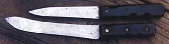 The author's 40-year-old retired trade blades, a sticker and a butcher, with customised timber grips.
