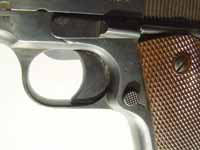 The magazine is released by compressing the round chequered button
